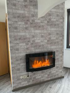 a fireplace with a brick wall at R&A in Elsdorf