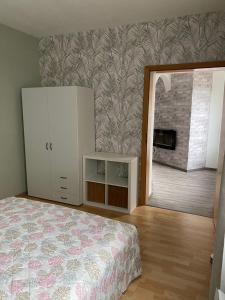 a bedroom with a bed and a fireplace at R&A in Elsdorf