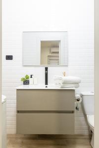 a bathroom with a sink and a mirror and a toilet at Oazis 1BR Apt,Central Old Town, Great location in Beer Sheva