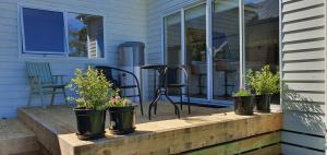 a porch with five potted plants on a house at Ballarat Holiday Homes - Hopetoun Cottage - Minutes from Ballarat CBD - Sleeps 1 to 6 in Ballarat