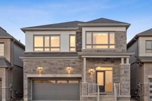 a large brick house with a garage at Barrie Luxe, Pool Table 6 BR 6 BA Custom Design A+ Location in Barrie