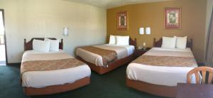a hotel room with two beds in a room at Budget Inn in Barstow