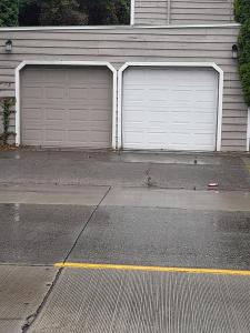 two garage doors on the side of a house at Cozy contemporary 2BR with Sofa bed in the office in Seattle