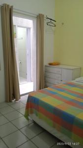 a bedroom with a bed and a window and a dresser at Hospedaria FOR755 in Fortaleza