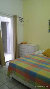 a bedroom with a bed and a dresser and a window at Hospedaria FOR755 in Fortaleza