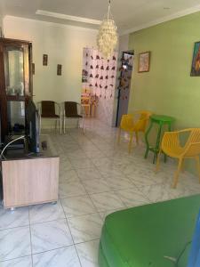 a waiting room with chairs and a tv in it at Porto Colore praça Sete in Porto De Galinhas