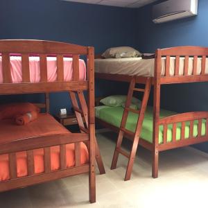a room with two bunk beds and a bed at Panama Hat Hostel in Panama City
