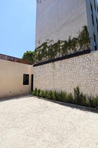 a stone wall next to a building with plants on it at Akbal Tulum in Tulum