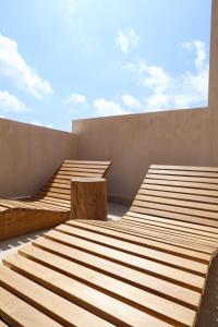 a group of wooden benches on top of a building at Akbal Tulum in Tulum