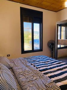 a large bed in a room with a window at Souf view in Jerash