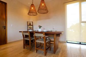 a dining room with a wooden table and chairs at Akbal Tulum in Tulum