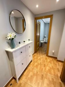 a bathroom with a white dresser and a mirror at Apartamento Zaragoza Picarral in Zaragoza +43 photos