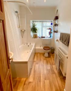 een badkamer met een bad, een toilet en een wastafel bij Cottage in the Heart of Frome in Frome