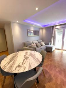 a living room with a table and a couch at Apartamento Zaragoza Picarral in Zaragoza