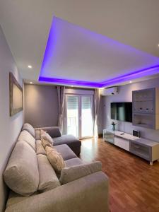 a living room with a couch and a blue light at Apartamento Zaragoza Picarral in Zaragoza