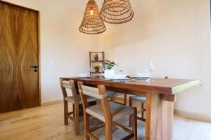 a dining room with a wooden table and chairs at Akbal Tulum in Tulum