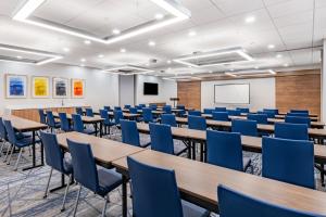 a conference room with tables and chairs and a whiteboard at Holiday Inn Express & Suites - Nephi, an IHG Hotel in Nephi