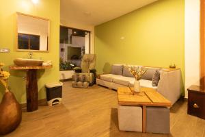 a living room with a couch and a sink at El Guayabal de Mindo in Mindo
