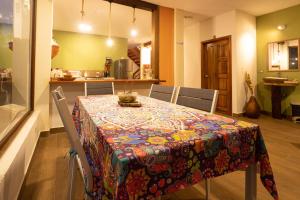 a dining room with a table with a colorful table cloth at El Guayabal de Mindo in Mindo