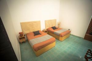 Postel nebo postele na pokoji v ubytování Casa Sofi Oaxaca