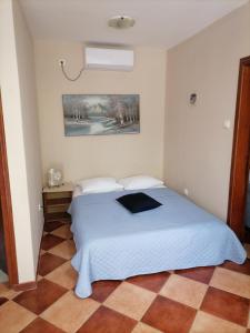 a bedroom with a white bed in a room at Apartments Ant in Budva