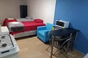 a small room with a bed and a table and a chair at Suite Estudio 2 Buena Vista Santa Tecla in Nueva San Salvador