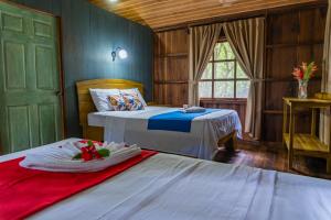 a bedroom with two beds and a green door at Hidden Paradise Lodge in Drake