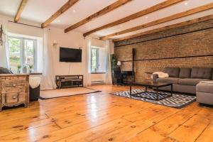 a living room with a couch and a brick wall at MTL Artist Loft - Champs in Montréal