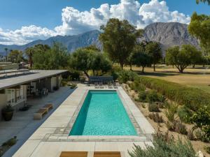 a swimming pool with mountains in the background at The Milky Way Modern Desert Retreat in Borrego Springs