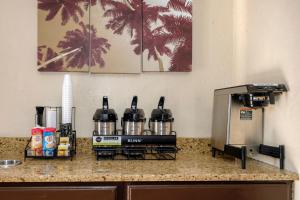 a counter with three bottles of wine sitting on top of it at Red Roof Inn Jacksonville - Cruise Port in Jacksonville