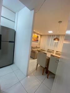 a kitchen and living room with a table and chairs at Praia de jangada 103 - barra de jangada recife in Recife