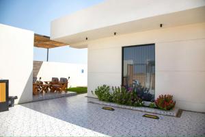 a view of a house with a patio at المرفأ 2 شاليه مع مسبح والعاب مائية وغرف نوم فاخرة in Khalij Salman