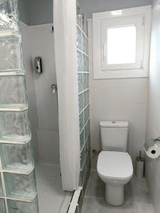 a white bathroom with a toilet and a window at ATALAYA DEL RÍO in Valderrobres +22 photos