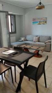 a living room with a table and a couch at Lefkas Apartment in Lefkada Town