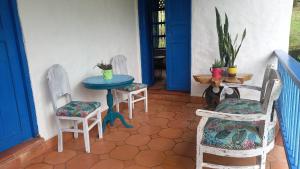 a patio with chairs and a table and a table and chairs at Hacienda San Francisco in Venecia