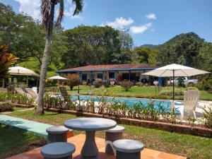 a view of a resort with a pool and tables and chairs at Hacienda San Francisco in Venecia