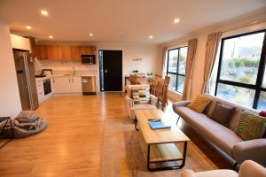 a living room with a couch and a table at Alpine Star in Lake Tekapo