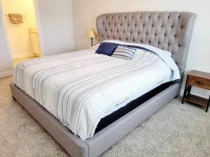 a large bed in a bedroom with a bed frame at Brand NEW house in Pensacola EV connector included in Pensacola