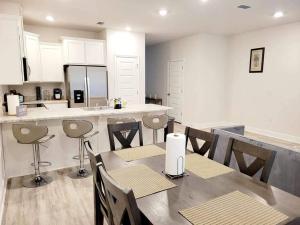 a kitchen with a table and chairs and a counter at Brand NEW house in Pensacola EV connector included in Pensacola