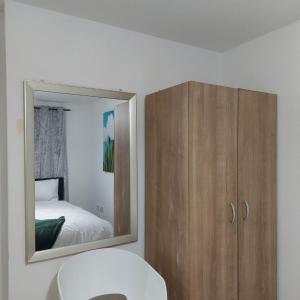 ein Bad mit einem Spiegel und ein Schrank mit einem Bett in der Unterkunft 2 Bedroom 2 Bathroom Free Parking Nearby in Manchester