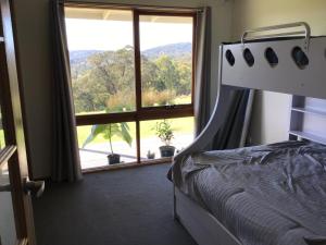 a bedroom with a bed and a large window at Valley Views in Montrose