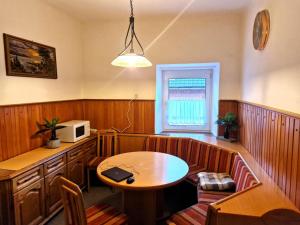 a dining room with a table and a microwave at Cosy apartment in Arnoldstein with garden in Arnoldstein