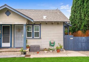 a small house with a blue fence in a yard at Cozy Oceanside Retreat-Walk to Beach! in Oceanside