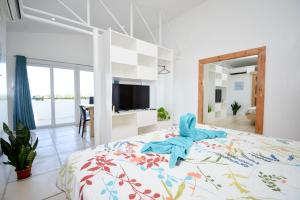 a bedroom with a bed with a blue towel on it at Babosam Apartments in Boracay