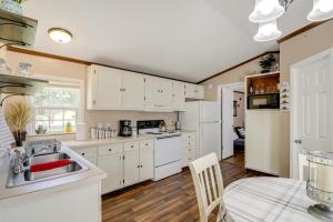 a kitchen with white cabinets and a table and a tableablish at Pet-Friendly Corbin Vacation Rental about 4 Mi to Town in Corbin