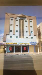 a building on a street in front of a building at شقق نجوم الجزيرة للشقق المخدومة in Tabuk