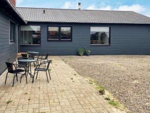 a patio with tables and chairs in front of a house at 4 star holiday home in Harboøre-By Traum in Harboør