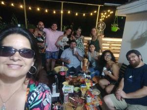 a group of people posing for a picture at a party at La Cage in San Miguel de Tucumán