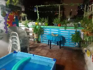 a patio with a pool and a table and potted plants at La Cage in San Miguel de Tucumán