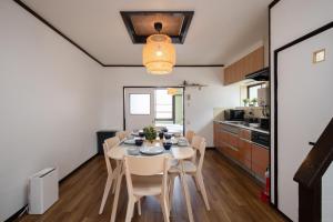 a kitchen and dining room with a table and chairs at 【鶴木宿】 in Osaka